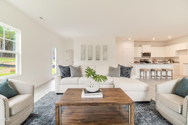 living room with dark wood-style floors, visible vents, and recessed lighting