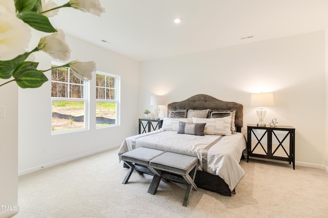 bedroom featuring recessed lighting, light colored carpet, visible vents, and baseboards