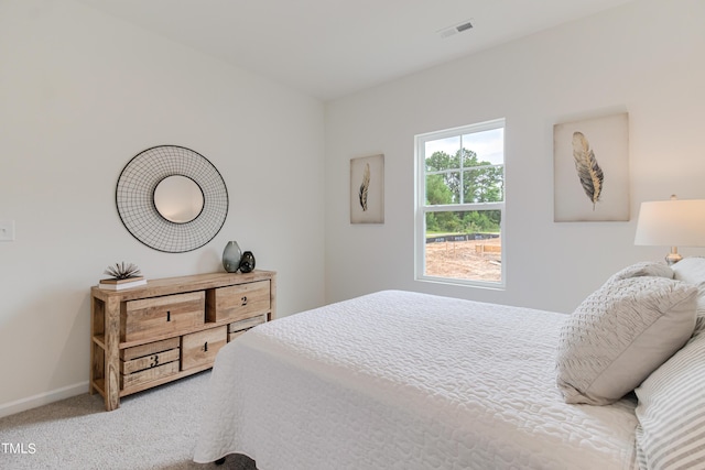 bedroom with carpet floors, baseboards, and visible vents