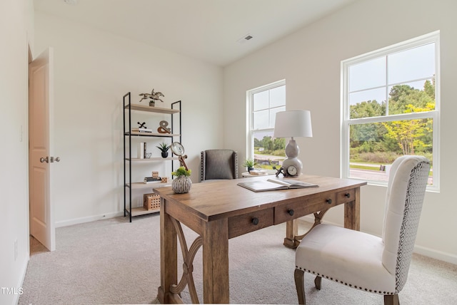 home office with light colored carpet, visible vents, and baseboards