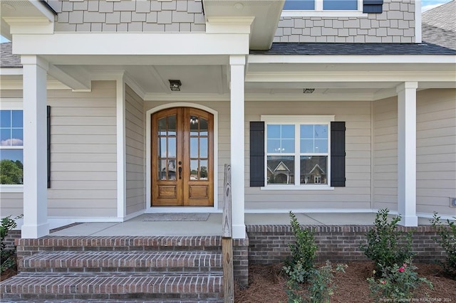 entrance to property featuring french doors and covered porch