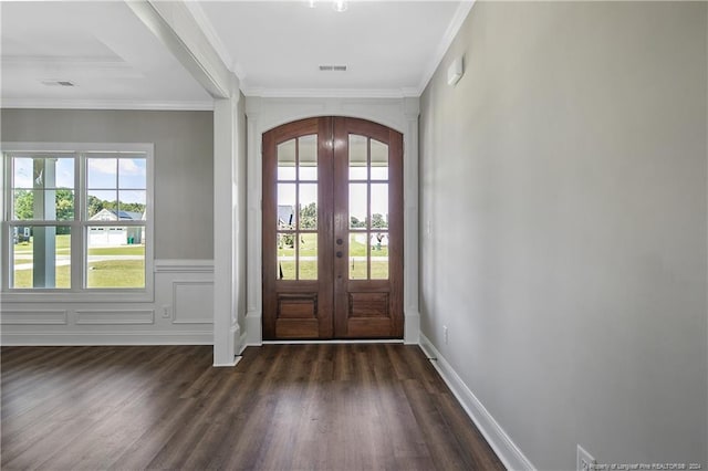 foyer with dark hardwood / wood-style floors, crown molding, and french doors