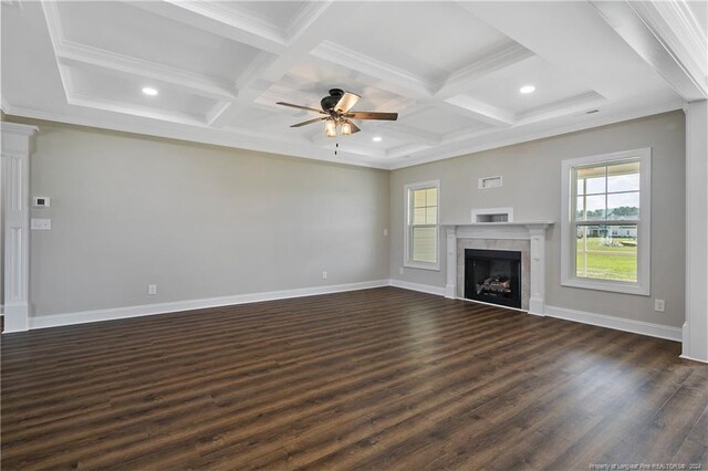 unfurnished living room featuring coffered ceiling, dark hardwood / wood-style floors, a tile fireplace, beam ceiling, and ceiling fan