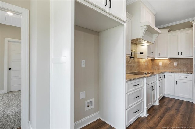 kitchen with white cabinets, dark hardwood / wood-style flooring, and light stone countertops