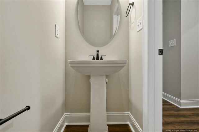 bathroom with hardwood / wood-style floors