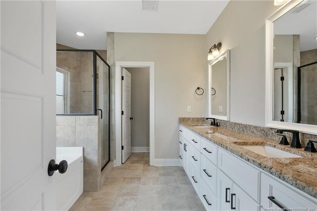 bathroom featuring vanity, independent shower and bath, and tile patterned flooring