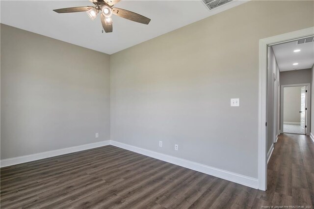 unfurnished room with ceiling fan and dark hardwood / wood-style floors