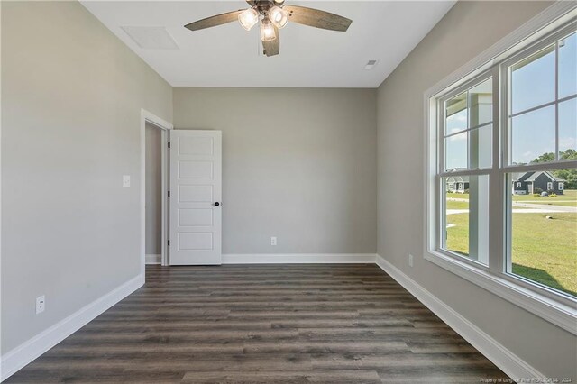 empty room featuring dark wood-type flooring, ceiling fan, and plenty of natural light