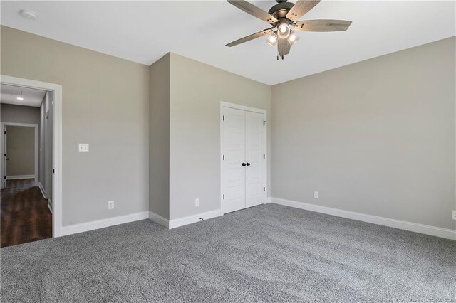 unfurnished bedroom with a closet, ceiling fan, and carpet