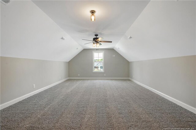 bonus room with lofted ceiling, ceiling fan, and carpet