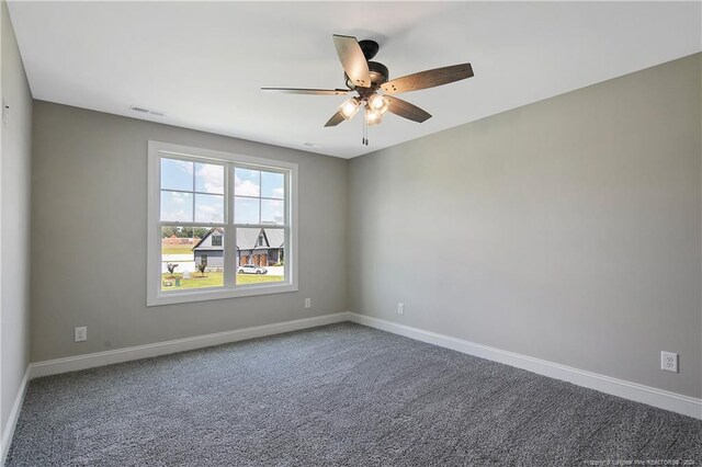 empty room with ceiling fan and carpet