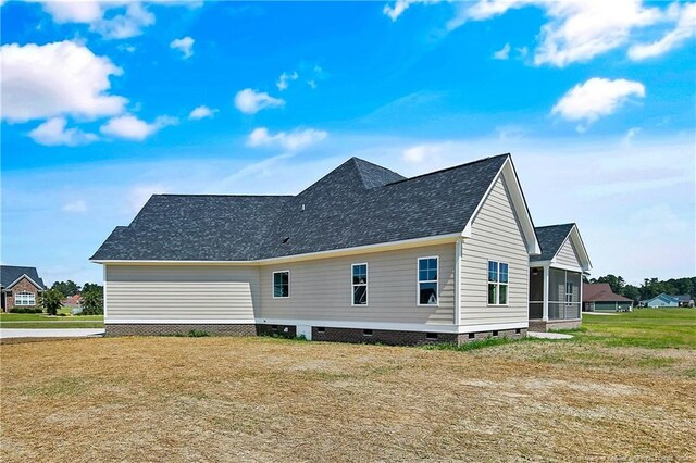 back of house with a lawn and a sunroom