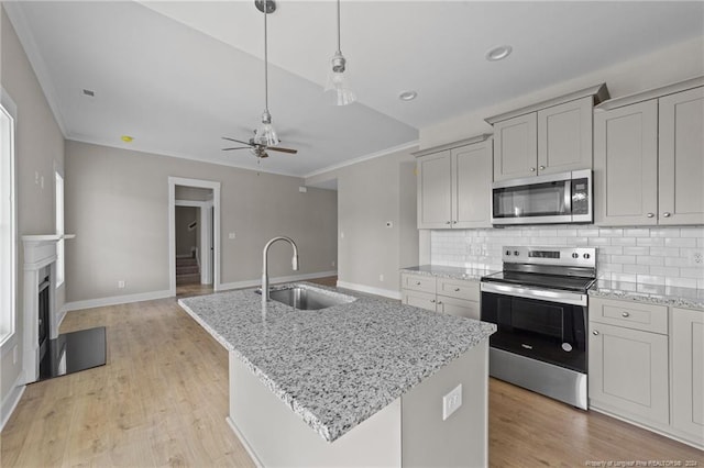300 Fields Rd Lot 5, Pikeville, NC 27863 - kitchen featuring light stone countertops, a kitchen island with sink, stainless steel appliances, sink, and ceiling fan