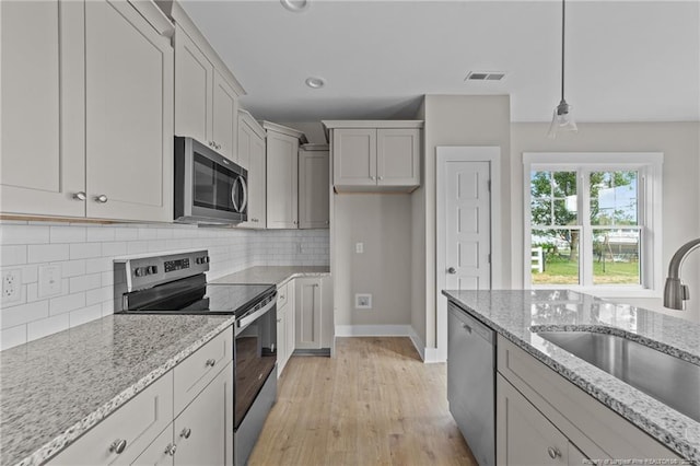 300 Fields Rd Lot 5, Pikeville, NC 27863 - kitchen featuring light hardwood / wood-style flooring, light stone countertops, stainless steel appliances, sink, and pendant lighting