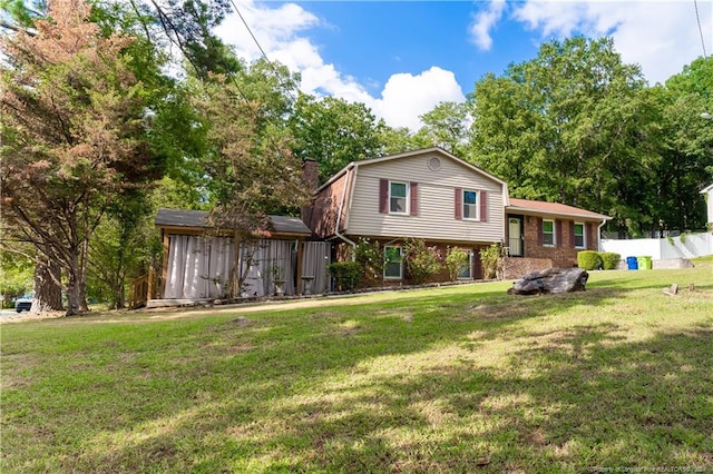 view of front of property with a storage shed and a front yard