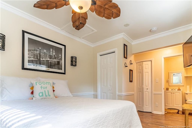 bedroom featuring ceiling fan, light hardwood / wood-style floors, crown molding, and ensuite bath