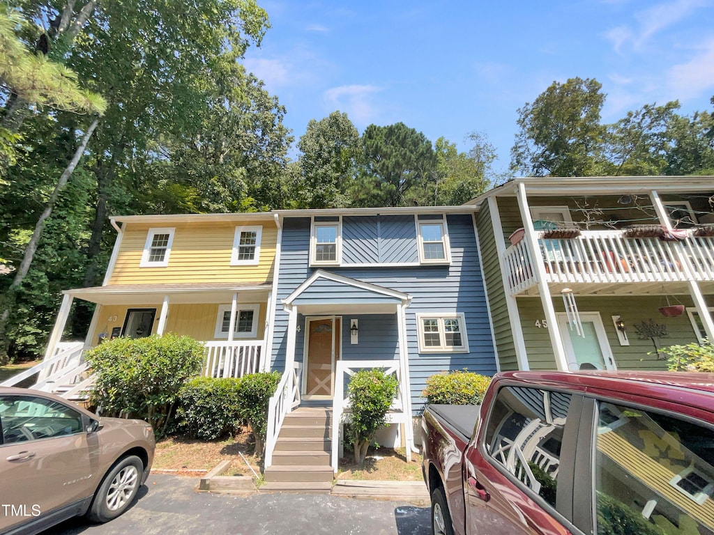 view of property with a balcony and a porch