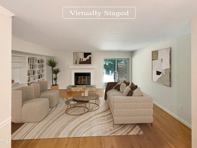 living room with a textured ceiling and wood-type flooring