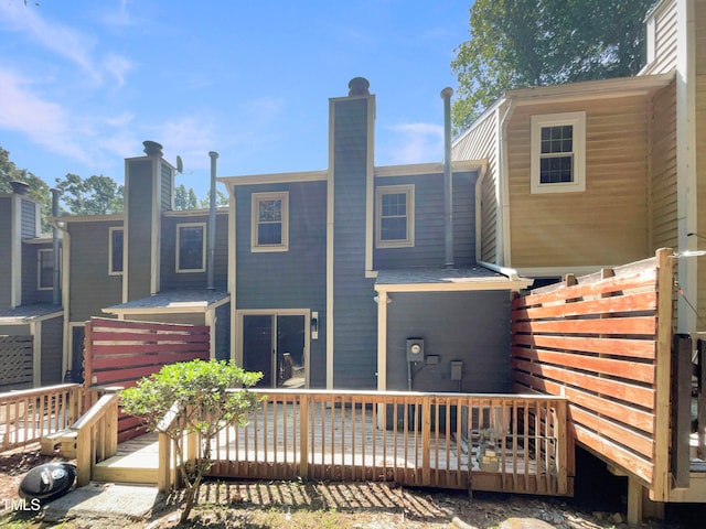 back of property featuring a wooden deck