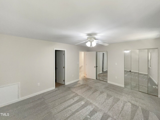 spare room featuring light colored carpet and ceiling fan