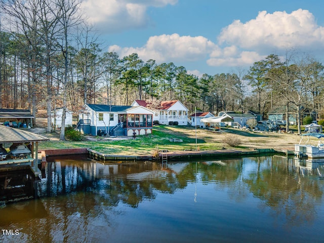 dock area featuring a lawn and a water view