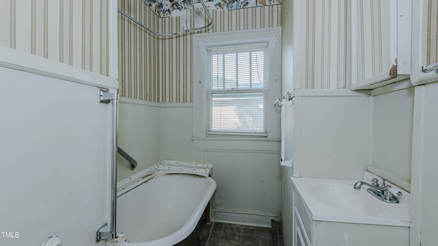 bathroom with a washtub and vanity