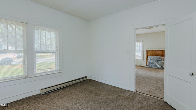 carpeted spare room with plenty of natural light, baseboard heating, and crown molding