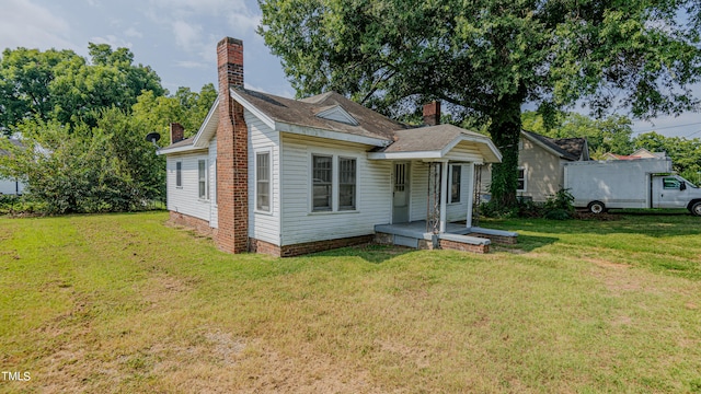 bungalow-style home featuring a front lawn