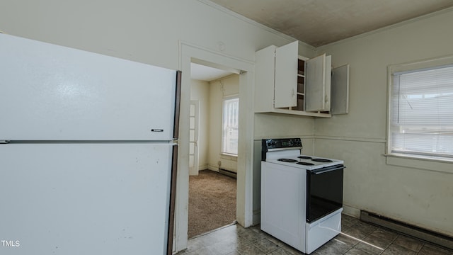 kitchen with white appliances, baseboard heating, crown molding, and a healthy amount of sunlight