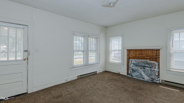 unfurnished living room with baseboard heating, ornamental molding, carpet floors, and a fireplace