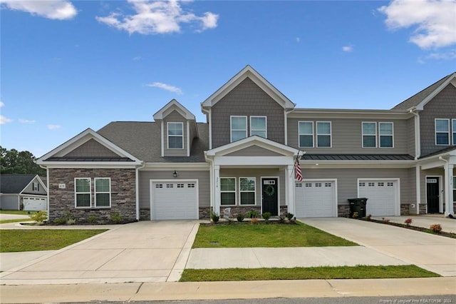 craftsman house featuring a garage and a front yard