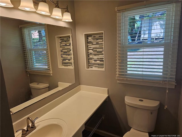 bathroom featuring toilet and vanity