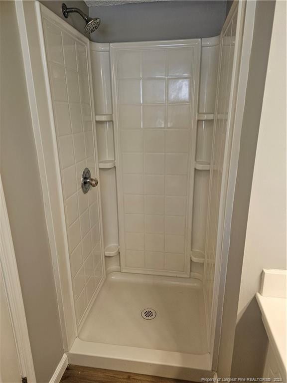 bathroom featuring a tile shower and vanity