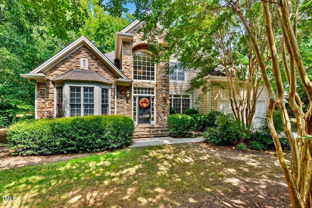 front facade featuring a garage and a front lawn