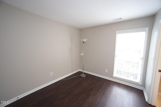 unfurnished room featuring dark wood-type flooring