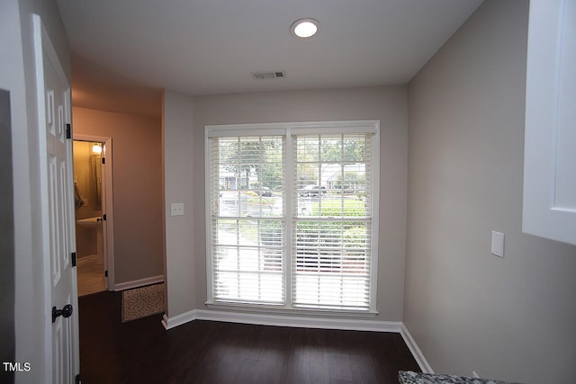 unfurnished room featuring dark hardwood / wood-style flooring