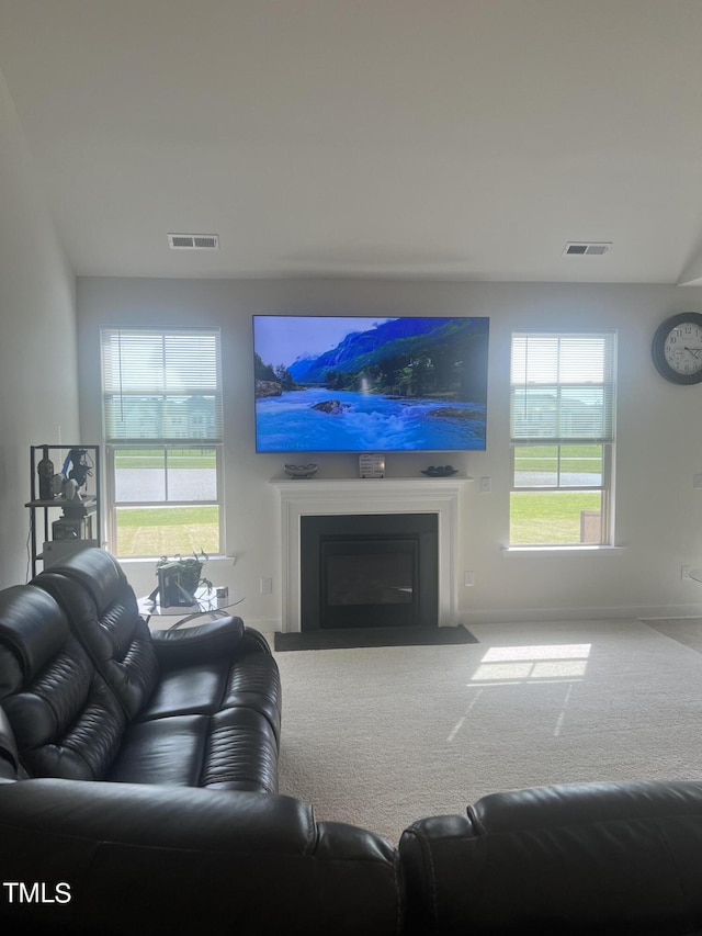 1565 Sage Treee Dr, Zebulon, NC 27597 - carpeted living area with baseboards, visible vents, and a fireplace with flush hearth