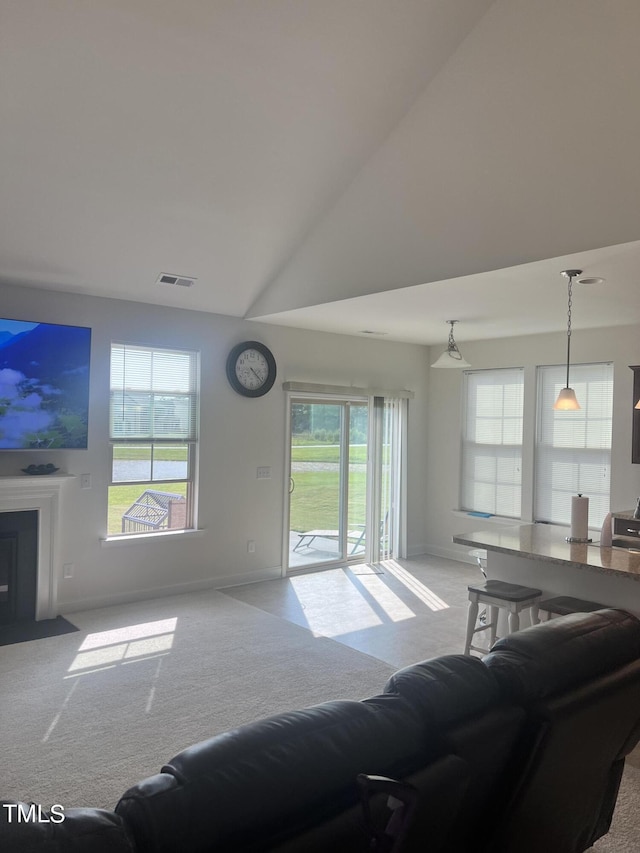 1565 Sage Treee Dr, Zebulon, NC 27597 - carpeted living area featuring baseboards, plenty of natural light, high vaulted ceiling, and visible vents