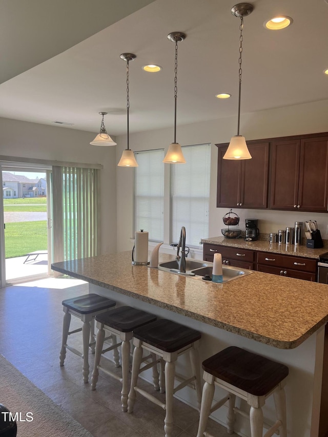 1565 Sage Treee Dr, Zebulon, NC 27597 - kitchen with a sink, recessed lighting, a kitchen bar, and an island with sink
