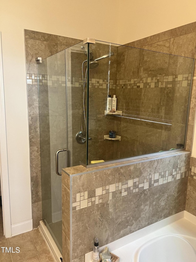 1565 Sage Treee Dr, Zebulon, NC 27597 - bathroom with a garden tub, tile patterned flooring, and a stall shower