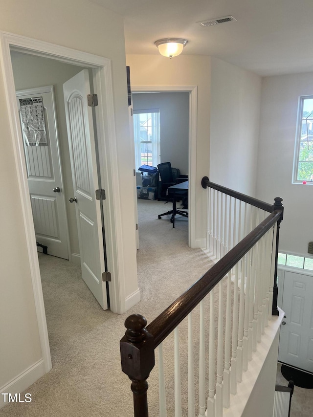 1565 Sage Treee Dr, Zebulon, NC 27597 - hall with carpet floors, visible vents, baseboards, and an upstairs landing