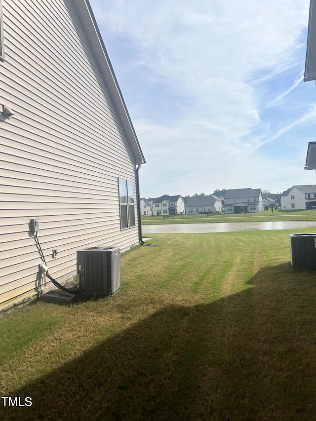 1565 Sage Treee Dr, Zebulon, NC 27597 - view of yard with central air condition unit, a water view, and a residential view