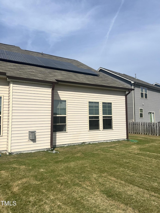 1565 Sage Treee Dr, Zebulon, NC 27597 - back of house with fence, a yard, and solar panels