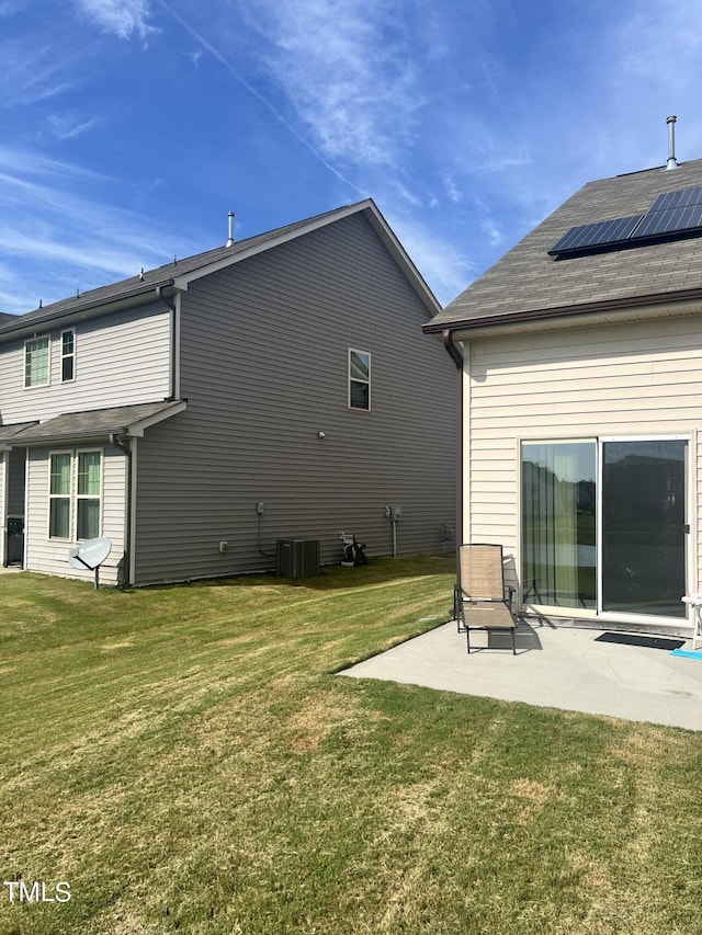 1565 Sage Treee Dr, Zebulon, NC 27597 - rear view of house featuring a lawn, a patio area, central air condition unit, and solar panels