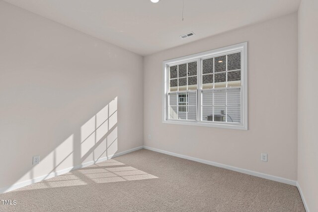 spare room with light colored carpet