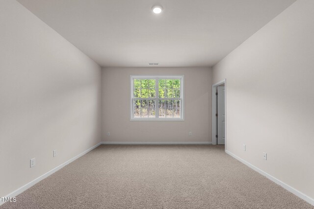 unfurnished room with light colored carpet