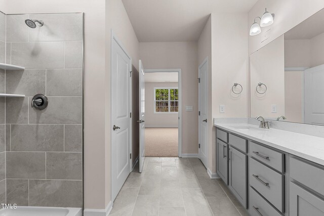 bathroom featuring vanity, tiled shower, and tile patterned floors