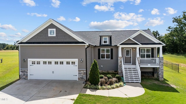 craftsman-style home featuring a garage, a front yard, and covered porch