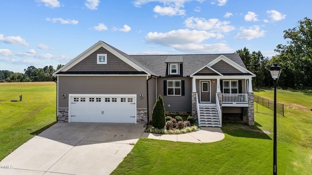 craftsman-style house featuring a garage, covered porch, and a front yard