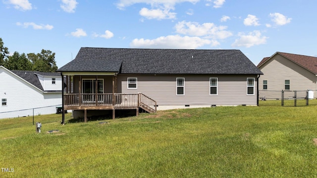 rear view of property featuring a yard and a wooden deck